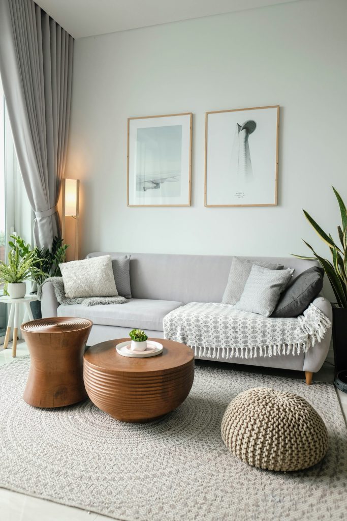 Bright living room with a neutral sofa, cushions and large window